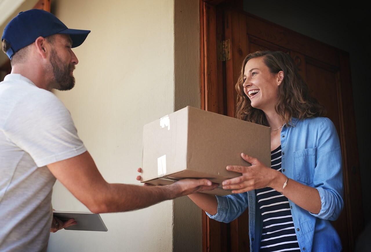 woman receiving a package from the delivery guy