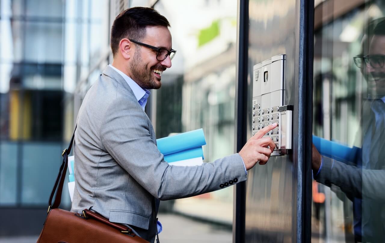 man pressing an intercom button