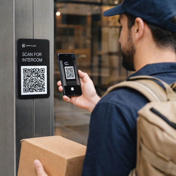 delivery person uses smartphone to scan qr code plaque