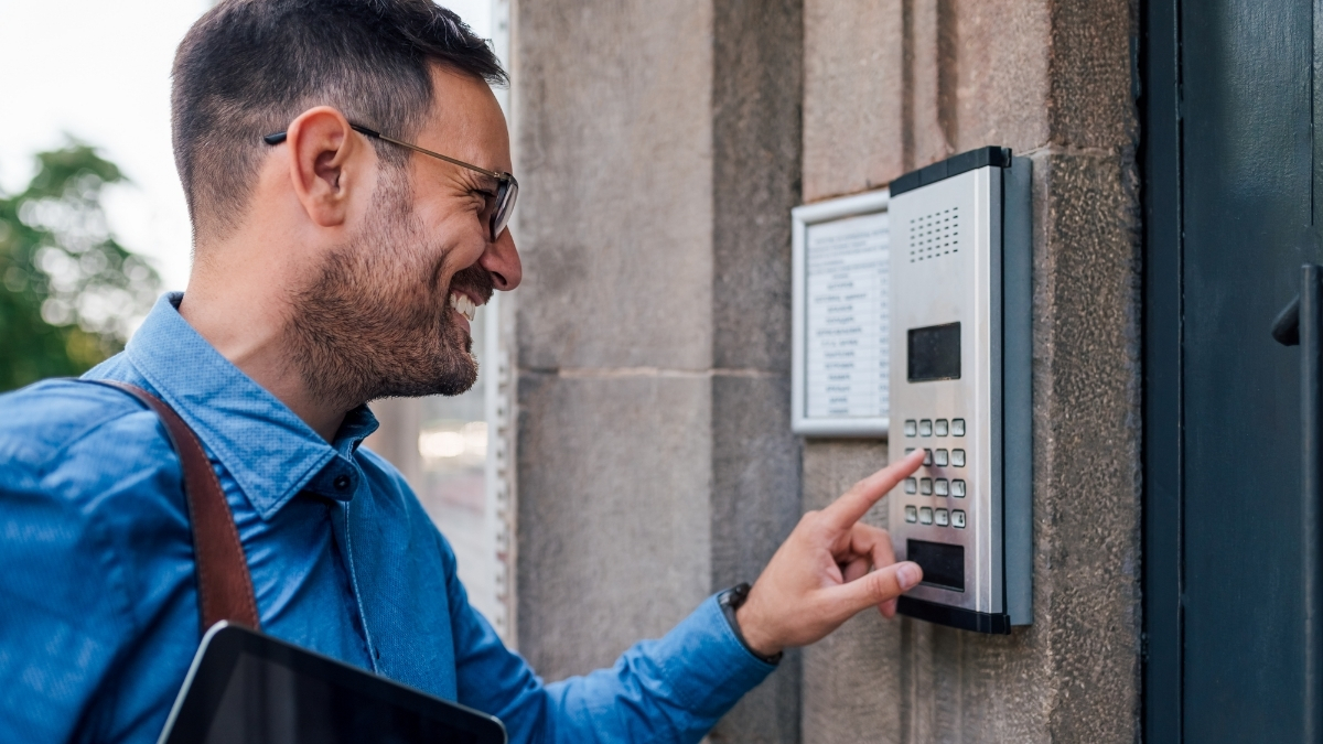 visitor presses on wired intercom system