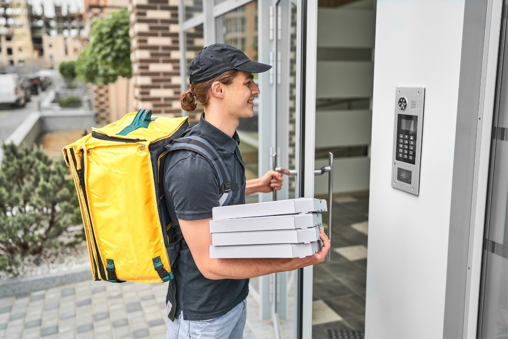 delivery driver brings pizza
