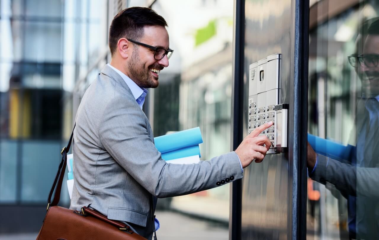 Man pressing the buttons of an intercom system