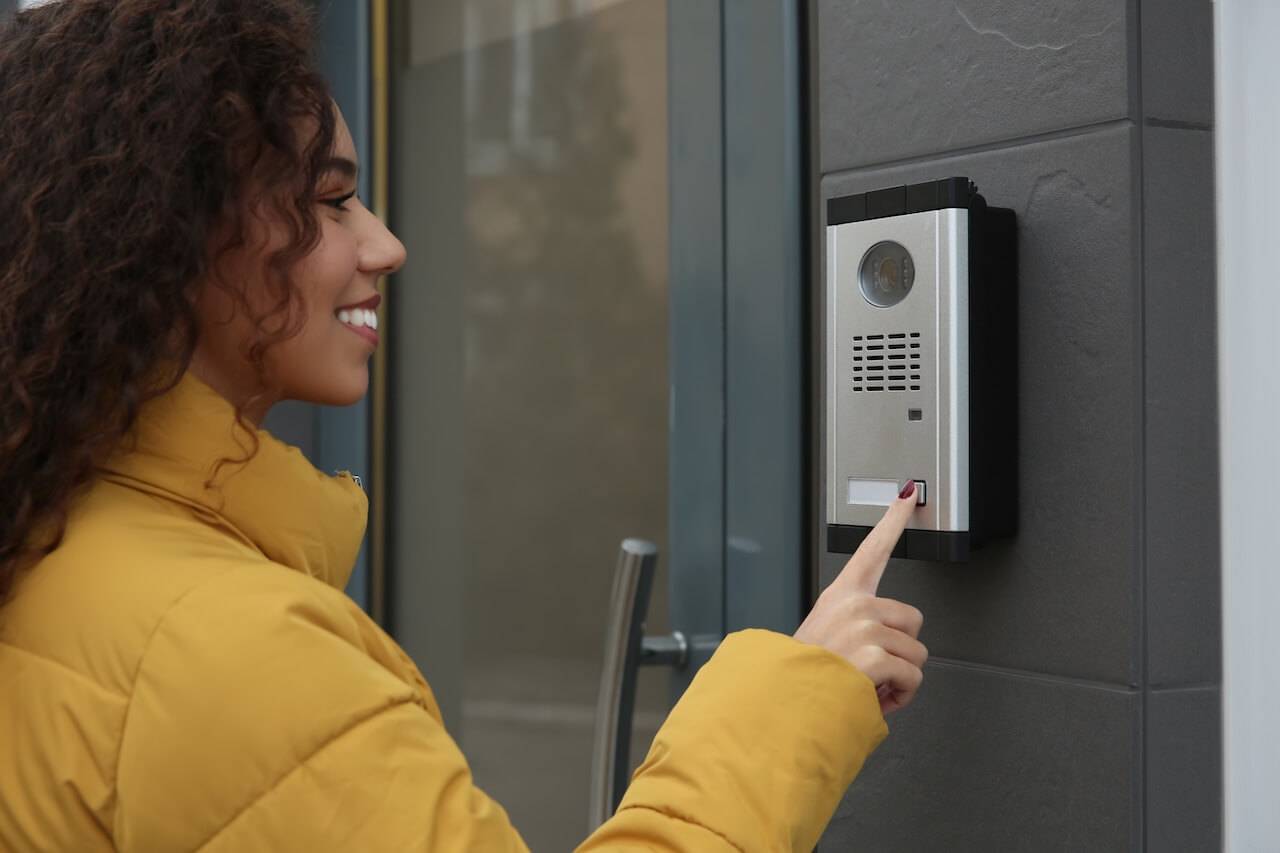 woman pressing the intercom button
