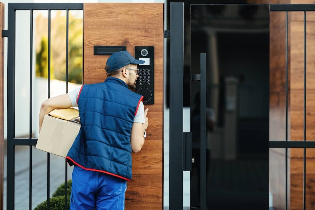courier ringing on customer's intercom while making home delivery