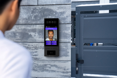 Swiftlane intercom mounted on a wall near the gate