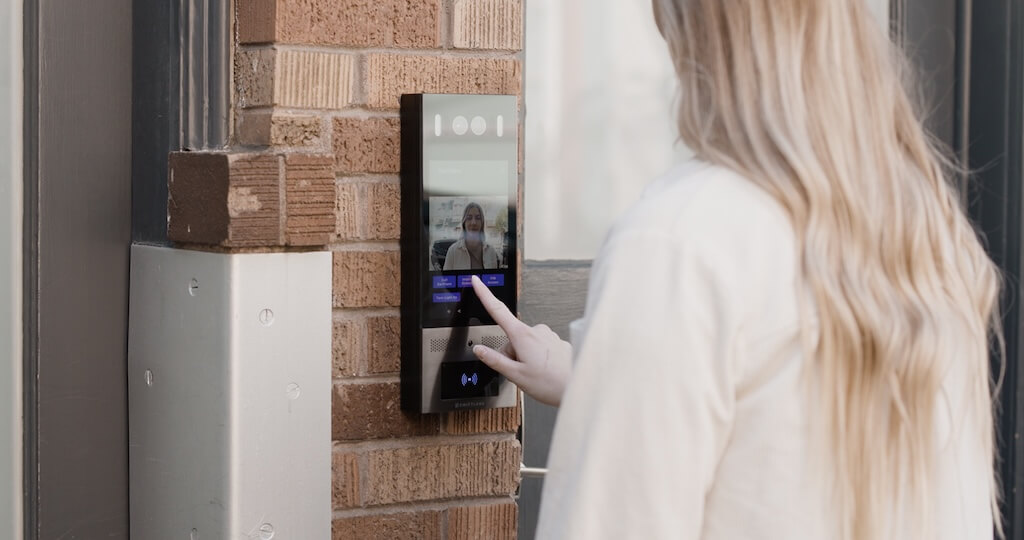 Woman using a building intercom
