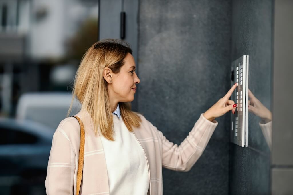 female presses the intercom button