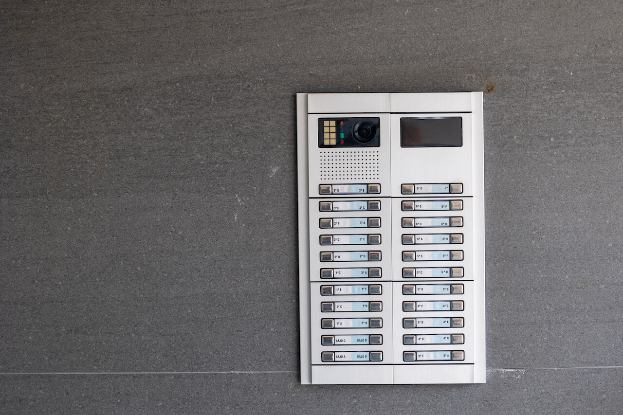 Intercom system showing multiple apartments on building exterior wall 