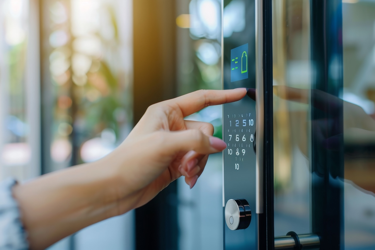 woman's finger entering password code on the smart digital touch screen keypad entry door lock