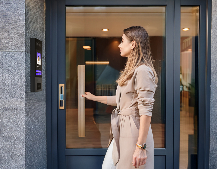 woman entering a salon suite through video intercom