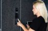 woman using the intercom to enter the building