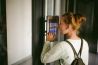 teenager schoolgirl dials the code for a call over the intercom 