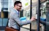 man pressing an intercom button