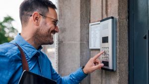 visitor presses on wired intercom system