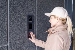 female visitor presses intercom system