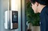 man using face scanner to unlock glass door