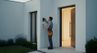 Smart home technician installing security system or intercom on modern house exterior wall