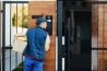 courier ringing on customer's intercom while making home delivery