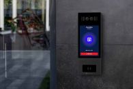 Swiftlane intercom mounted on a gray wall