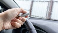 person using clicker to open gate from inside a car