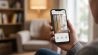 Person checks live video doorbell feed on smartphone