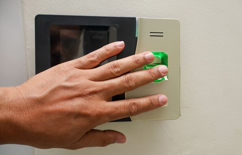 person scanning fingerprint on a reader