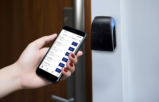 person using the swiftlane app to unlock using rfid technology reader