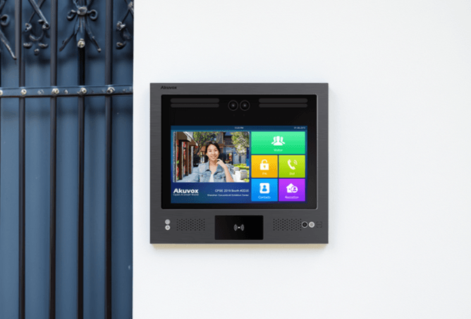 Akuvox X916 intercom mounted on a wall next to an apartment entrance