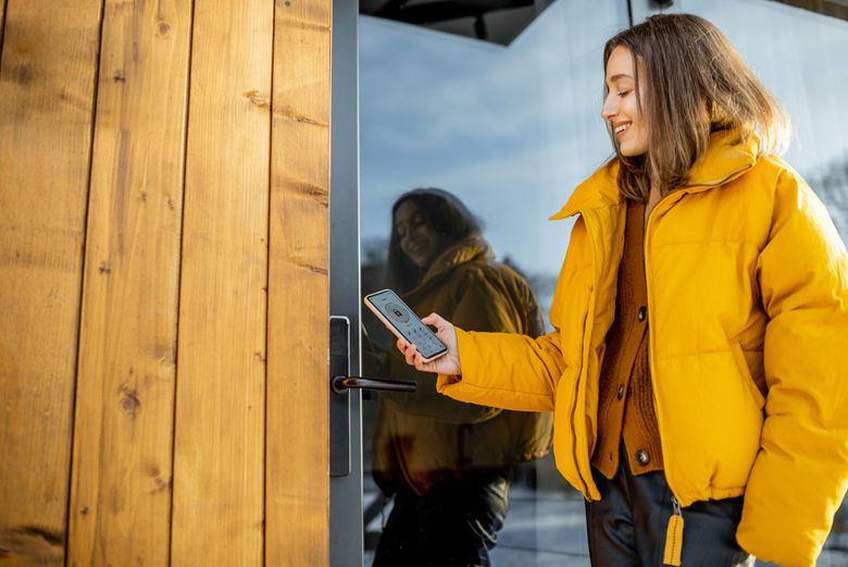 woman opening keyless lock through phone