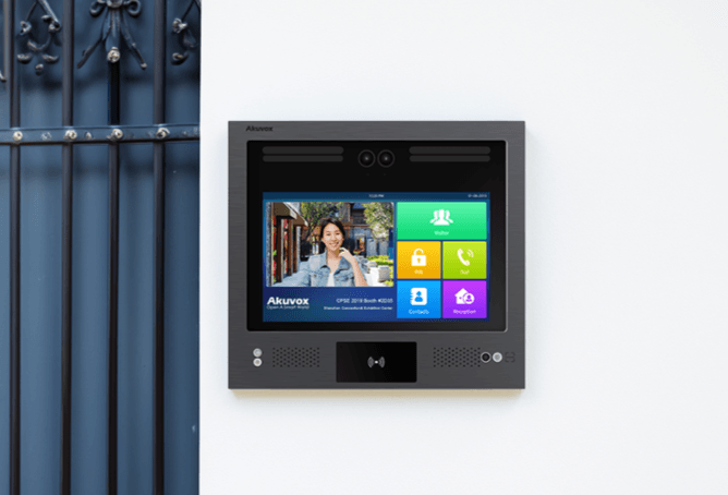 Akuvox X916 intercom mounted on a wall next to an apartment entrance